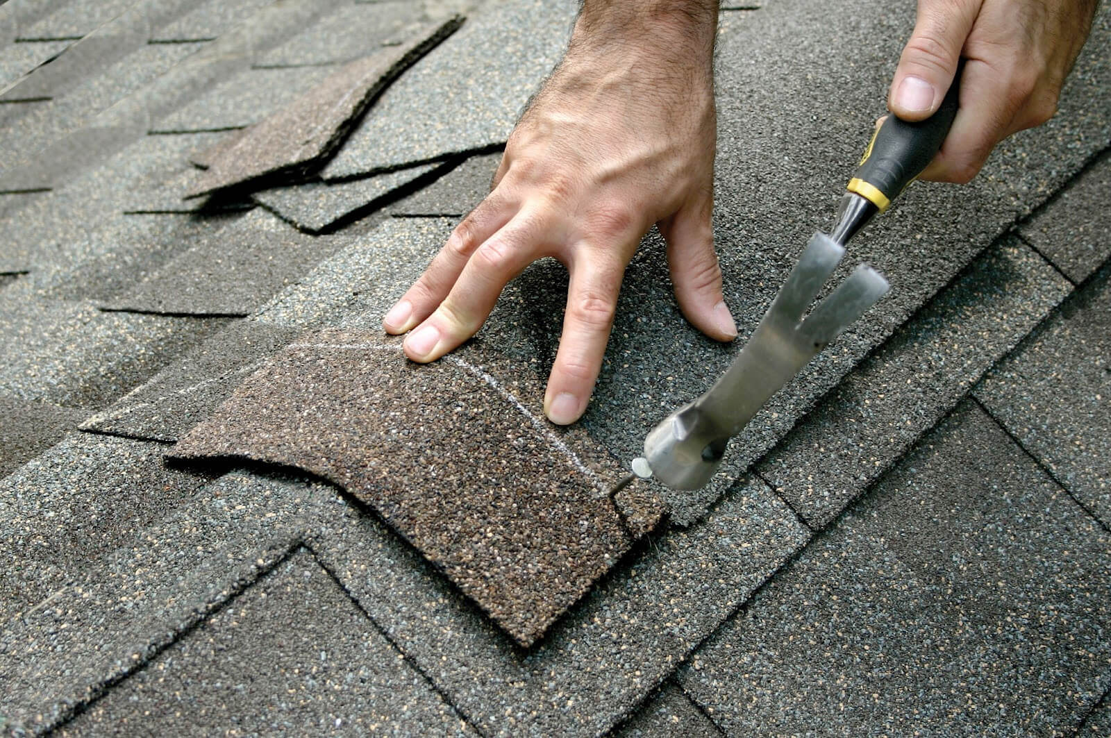 Roof repairs in Nashville, Murfreesboro, and Franklin by Constructandtrade . picture of shingle being hammered in.